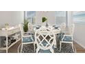 Elegant dining room featuring a stylish table set, decorative rug, and natural light at 206 Belfort Way, Summerville, SC 29486