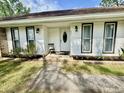 Inviting front porch with a decorative chair and a well-manicured lawn leading to the entrance at 207 Longstreet St, Summerville, SC 29486