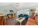 Cozy living room featuring stylish furnishings, a vaulted ceiling, and ample natural light at 208 Sea Cloud Cir, Edisto Island, SC 29438