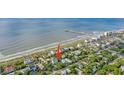 Gorgeous aerial view of the house near the beach, featuring beach access and lush landscaping at 220 E Arctic Ave, Folly Beach, SC 29439