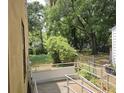 Backyard view from the elevated deck with metal railings and mature trees at 2313 Aintree Ave, North Charleston, SC 29405