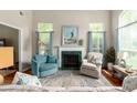 Cozy living room with fireplace, comfortable seating, and bright windows at 2632 Planters Pointe Blvd, Mount Pleasant, SC 29466