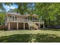 Elevated back deck and screened porch overlooking a spacious yard, ideal for outdoor entertaining and relaxation at 3021 Rushland Mews, Johns Island, SC 29455