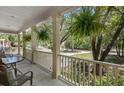 Inviting front porch with comfortable seating and hanging plants, perfect for enjoying the serene neighborhood view at 3021 Rushland Mews, Johns Island, SC 29455
