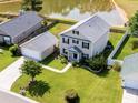 Aerial view of a well-maintained home with a lush green lawn and pond in the backyard at 303 Seneca River Dr, Summerville, SC 29485