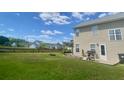 Spacious backyard featuring a wooden deck, fire pit, and a fenced yard at 303 Seneca River Dr, Summerville, SC 29485