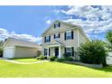 Attractive two-story home with black shutters, covered porch, and landscaped front yard at 303 Seneca River Dr, Summerville, SC 29485