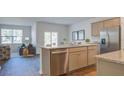 Bright kitchen featuring an island, stainless steel appliances, and an open floor plan to the living room at 311 Willow Run Dr, Summerville, SC 29486