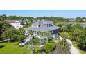 Beautiful two-story home with a lush lawn, mature landscaping, and views of the adjacent marina at 314 Commonwealth Rd, Mount Pleasant, SC 29466