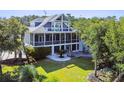 Inviting two-story home with a screened porch, outdoor patio, and a spacious backyard at 314 Commonwealth Rd, Mount Pleasant, SC 29466