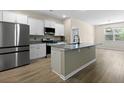 Bright kitchen with granite countertops, stainless steel appliances, and an eat-in island at 318 Bering Ln, Summerville, SC 29486