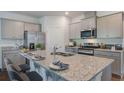 Bright kitchen with granite countertops, stainless steel appliances, and a large island with seating at 323 Willow Run Dr, Summerville, SC 29486