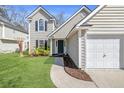 Inviting home exterior featuring well-kept landscaping, a two-car garage and charming front entry at 350 Arlington Dr, Charleston, SC 29414