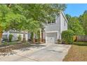 Attractive two-story home with light siding, stone accents, a garage, and a concrete driveway at 3661 Locklear Ln, Mount Pleasant, SC 29466
