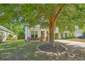 Charming single-Gathering home with tidy landscaping, a red door, and a healthy shade tree at 3661 Locklear Ln, Mount Pleasant, SC 29466
