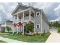 Charming two-story home featuring a spacious porch, landscaped yard, and inviting curb appeal at 397 Woodgate Way, Summerville, SC 29485