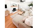 Bright living room features hardwood floors, a ceiling fan, and cozy furniture arrangement at 404 Rose Ln, Summerville, SC 29485