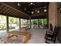 Outdoor pavilion with picnic tables, rocking chairs, fireplace and brick accents at 4151 Collins Dr, Charleston, SC 29414