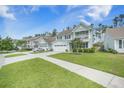 A picturesque street view showcases a row of beautifully designed homes with lush green lawns at 419 Whispering Breeze Ln, Summerville, SC 29486