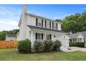 Two-story home with white siding, black shutters, manicured lawn, and inviting front porch at 4301 Trevor St, North Charleston, SC 29420