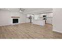 Open concept living room with fireplace that flows seamlessly into a kitchen with modern appliances at 4301 Trevor St, North Charleston, SC 29420