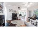 Open-concept living room with hardwood floors, fireplace, and view into the dining area at 700 Daniel Ellis Dr # 4107, Charleston, SC 29412