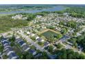 Aerial view of a beautiful neighborhood with a pond and lush greenery at 8009 Indian Hill Dr, Hanahan, SC 29410