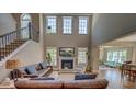 Inviting living room featuring a fireplace, soaring ceilings and plenty of natural light at 8009 Indian Hill Dr, Hanahan, SC 29410