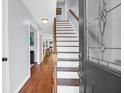 Bright foyer featuring hardwood floors and staircase, creating a welcoming entrance to the home at 1001 Foxcroft Rd, James Island, SC 29412