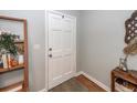 Bright entryway with a white door, wood floors, decorative accents, and stylish shelving at 104 Clover St, Summerville, SC 29483