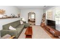 Inviting living room with green sofa, wood accents, and a view into another room at 104 Clover St, Summerville, SC 29483