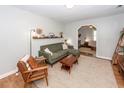 Cozy living room with green sofa, wood accents, neutral rug, and open archway at 104 Clover St, Summerville, SC 29483