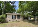 Traditional brick home featuring a well-manicured lawn and a quaint front porch at 106 Pelican St, Ladson, SC 29456
