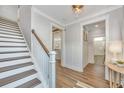 Welcoming foyer with hardwood floors, staircase, and elegant trim at 109 Gray Pine Ln, Summerville, SC 29483