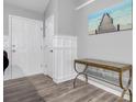 Inviting entryway with stylish flooring, decorative molding, and console table beneath an ocean-themed artwork at 109 Wisteria Ct, Summerville, SC 29486