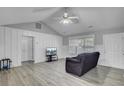 Bright living room with vaulted ceiling, modern flooring, and paneled walls for a cozy feel at 109 Wisteria Ct, Summerville, SC 29486
