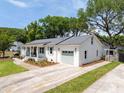 A single-story home with a gray roof, beautiful windows, an attached garage, and healthy green grass at 1199 Island View Dr, Mount Pleasant, SC 29464