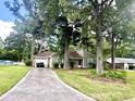 Lovely single-story home featuring an attached garage, mature trees, and a driveway in a quiet setting at 120 Wanda Dr, Summerville, SC 29485