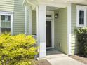 Entrance of a home with light green siding and a well-maintained front yard at 1225 Blakeway St # 703, Charleston, SC 29492
