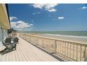 Relaxing deck with ocean view and Adirondack chairs at 128 Palmetto Blvd, Edisto Beach, SC 29438