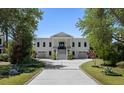 Elegant two-story home featuring a symmetrical facade, double doors, and a welcoming driveway at 1391 Royston Rd, Mount Pleasant, SC 29464