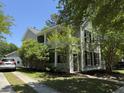 Two-story home with a inviting front porch, complimented by lush landscaping and a private driveway at 1418 Whispering Oak Trl, Mount Pleasant, SC 29466