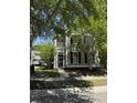 Inviting two-story home featuring a cozy front porch and beautifully landscaped surroundings at 1418 Whispering Oak Trl, Mount Pleasant, SC 29466