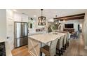 Modern kitchen with stainless steel appliances, a large center island, and stylish pendant lighting at 15 Edgewater Aly, Isle of Palms, SC 29451