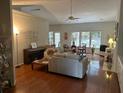 Open-concept living room with hardwood floors, vaulted ceiling, and large windows at 1578 Harborsun Dr, Charleston, SC 29412