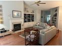 Bright living room with hardwood floors, fireplace, built-in shelves, and comfortable seating at 1578 Harborsun Dr, Charleston, SC 29412
