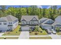 Two-story home with two-car garage, mature trees, landscaping, and a well-maintained lawn at 160 Cherry Grove Dr, Summerville, SC 29483