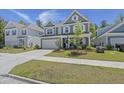 Charming two-story home with a manicured lawn, a two-car garage, and attractive landscaping at 160 Cherry Grove Dr, Summerville, SC 29483