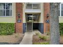 Close up of condo building entrance showing brickwork, stairs, lighting fixtures and unit numbers at 1600 Long Grove Drive # 811, Mount Pleasant, SC 29464