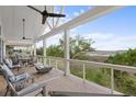 Relaxing back porch features comfortable seating, a modern fire pit, and views of the marshland at 1801 Landfall Way, Seabrook Island, SC 29455